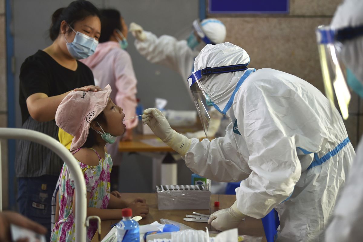 A nurse takes swab samples in the new rounds of Covid-19 testing in Nanjing in eastern China