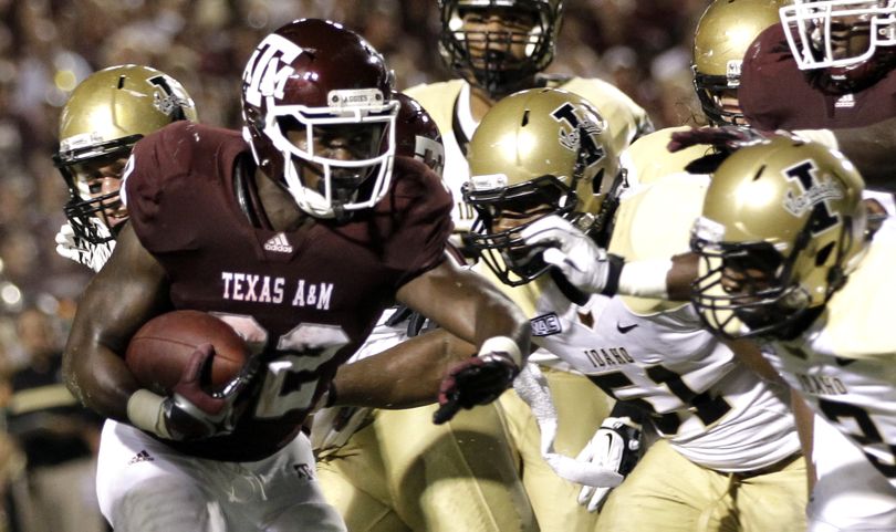 Texas A&M running back Cyrus Gray (32) rushes for a touchdown as Idaho linebacker Tre'Shawn Robinson (51) and cornerback Kenneth Patten (2) defend during the third quarter of an NCAA college football game Saturday, Sept. 17, 2011, in College Station, Texas. (David Phillip / Associated Press)