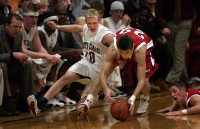 
North Idaho's Scotty Stockwell, left, puts on the brakes after Dixie's Ben Hartman scoops up a loose ball Friday night at Christenson Gym.
 (Tom Davenport / The Spokesman-Review)