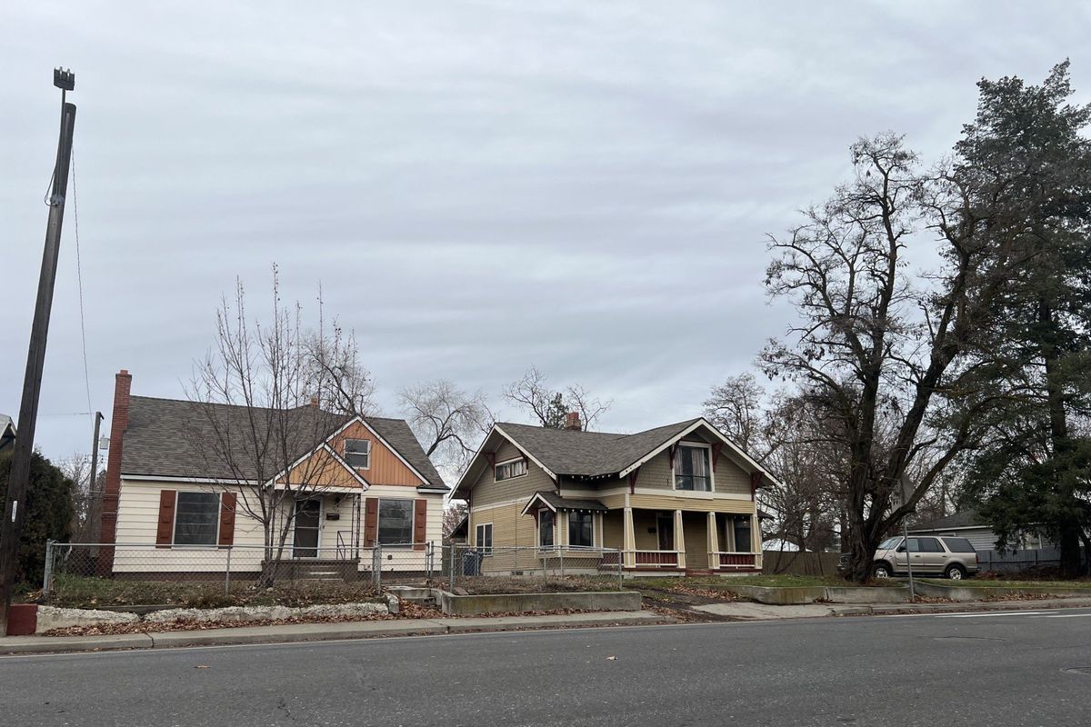 Plans call for demolishing these two homes, pictured, to make way for five new townhomes at 202 W. Buckeye Ave.  (Tod Stephens/For The Spokesman-Review)