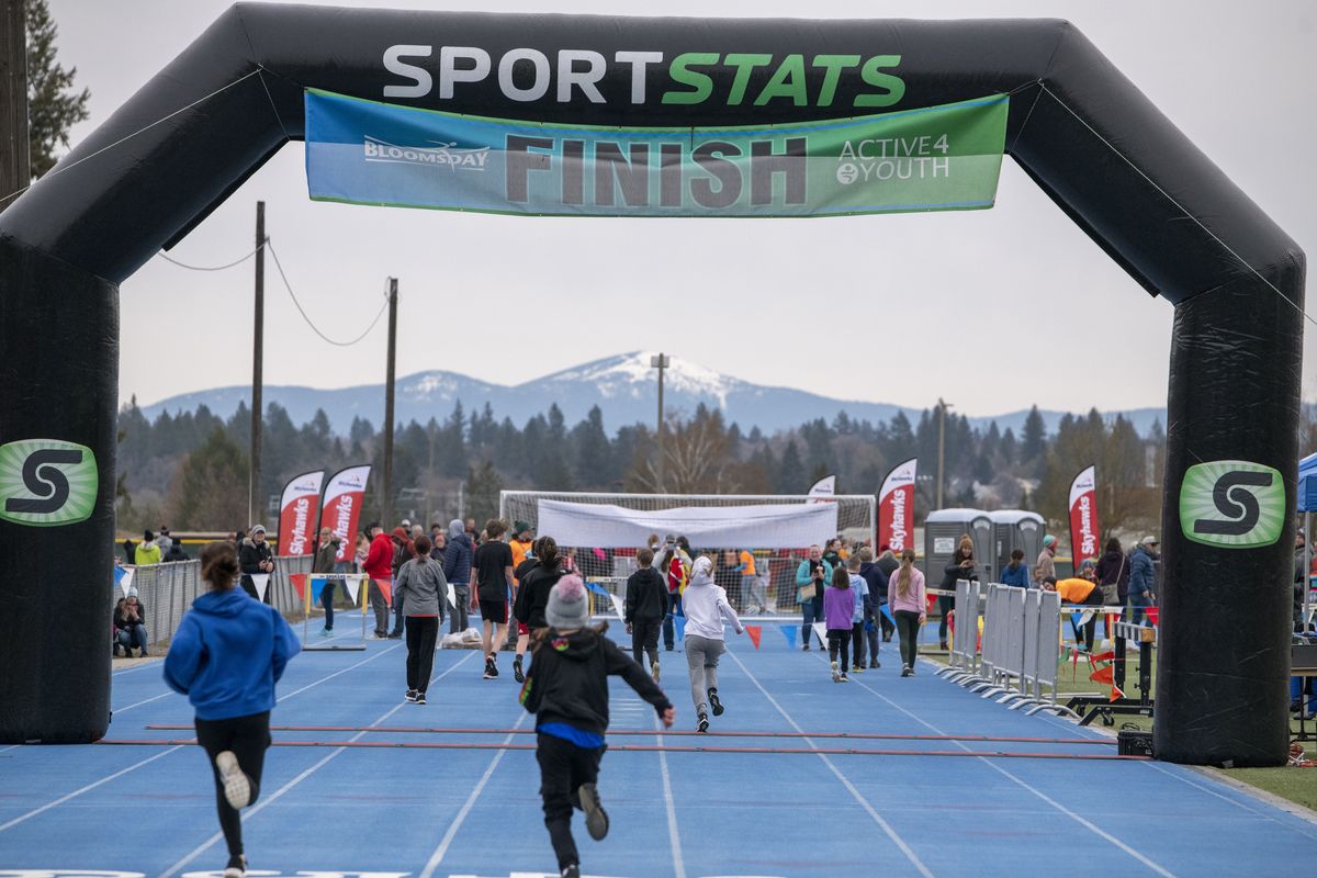 After they circled Spokane Falls Community College, runners finish on the running track at Junior Bloomsday Saturday, April 16, 2022 for a total run of just over a mile.  (Jesse Tinsley/THE SPOKESMAN-REVIEW)