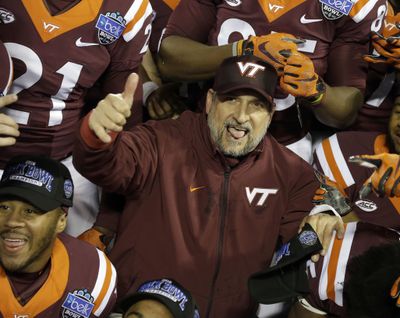 Virginia Tech associate head coach and defensive coordinator Bud Foster celebrates with his team after they held Arkansas scoreless in the second half and defeated the Razorbacks 35-24 in the Belk Bowl NCAA college football game in Charlotte, N.C., Thursday, Dec. 29, 2016. (Bob Leverone / Associated Press)