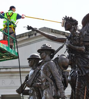 OLYMPIA -- Larry Tate of FS Ltd., cleans Winged Victory, the monument to World War I veterans on the Capitol Campus, on Tuesday, May 15. (Jim Camden)