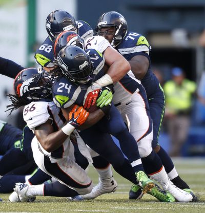 Seattle Seahawks running back Marshawn Lynch is on pace for similar rushing numbers to last season. (Associated Press)