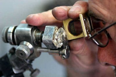 
A diamond is polished at the Krochmal and Cohen diamond factory in Johannesburg on Monday. The government has vowed to press ahead with legislative attempts to take greater control of the country's diamonds and weaken the grip of the de Beers giant, dismissing arguments that this could disrupt global markets and lead to job losses. 
 (Associated Press / The Spokesman-Review)