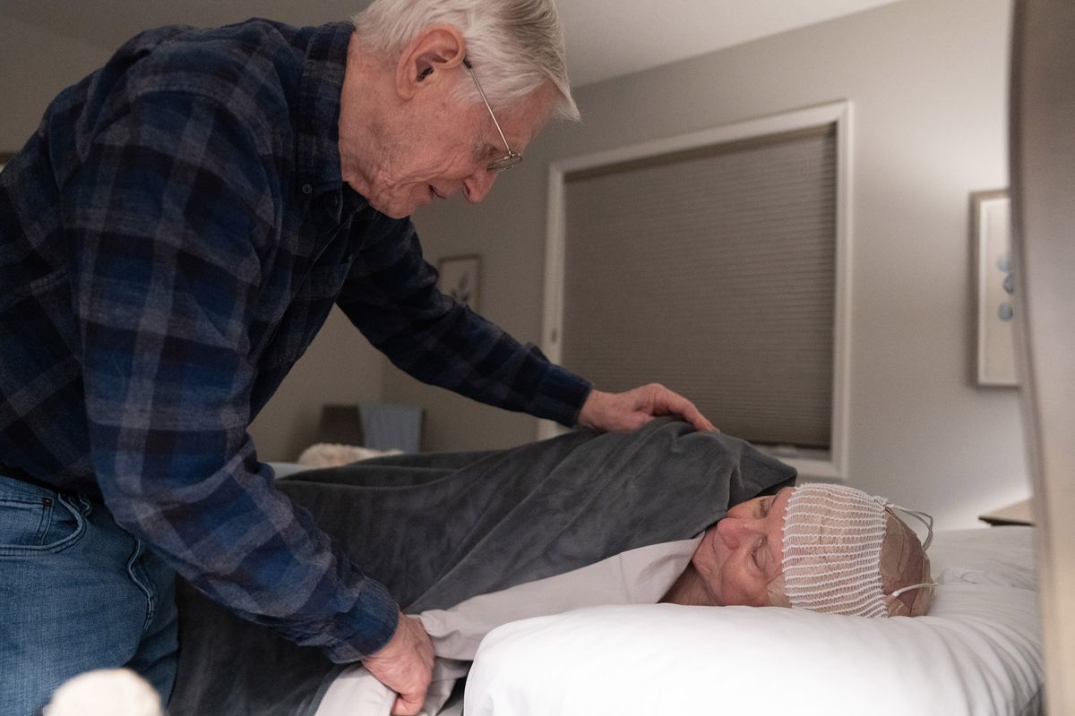 Jim Uden tucks in Nancy for bed, as he does most nights, on Feb. 23 at their home in Corcoran, Minn. Jim helps take care of Nancy in every way she lets him, including making her feel loved and supported.  (Alex Kormann/Minneapolis Star Tribune/TNS)
