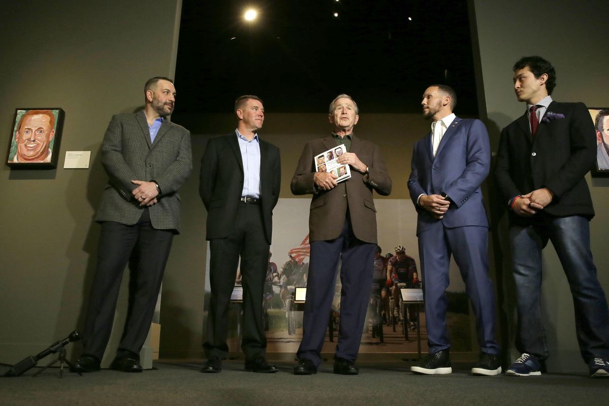Former President George W. Bush, center, stands with U.S. military veterans, from left, Robert Ferrara, James Williamson, Johnnie Yellock and Jay Fain during a press preview of an exhibition of his paintings of veterans in Dallas on Feb. 28. Bush painted portraits of the veterans and are featured in his book titled, "Portraits of Courage: A Commander in Chief