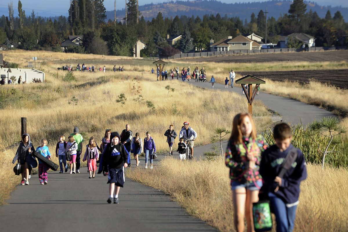 Students and parents walk to Moran Prairie Elementary School for International Walk to School Day on Wednesday.  (PHOTOS BY CHRISTOPHER ANDERSON)