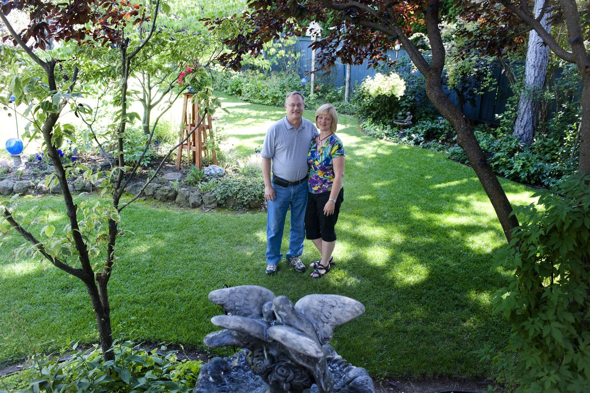 Wes and Lori Hein pose in the backyard of their south side home, where they’ve lived since 2007. (Tyler Tjomsland)