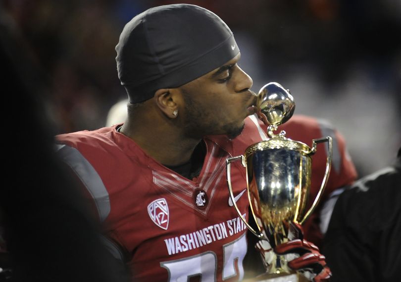 It’s a sweet-tasting apple Washington State's Tracy Clark puckers up to kiss following the Cougars’ comeback 31-28 Apple Cup win over Washington on Friday. (Tyler Tjomsland)