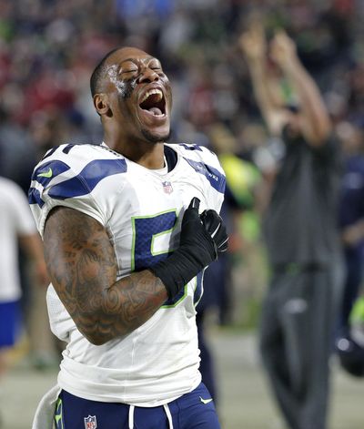 Seattle Seahawks outside linebacker Bruce Irvin  reacts to a touchdown on the bench during the second half against the Arizona Cardinals, Sunday, Dec. 21, 2014, in Glendale, Ariz. (Ross D. Franklin / AP)