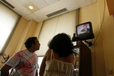 
In Old Havana, a couple watches President Bush's speech Wednesday about Cuba. Bush said the United States would support Cuba if it provides broad freedoms to its people.  Associated Press
 (Associated Press / The Spokesman-Review)