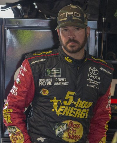 Martin Truex Jr. stands in the garage during practice for the NASCAR Cup Series auto race at Martinsville Speedway in Martinsville, Va., Saturday, March 24, 2018. (Matt Bell / Associated Press)