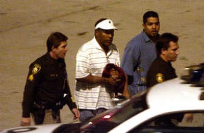 
O.J. Simpson, center, is taken to jail as he arrives at McCarran International Airport in Las Vegas on Friday. Associated Press
 (Associated Press / The Spokesman-Review)