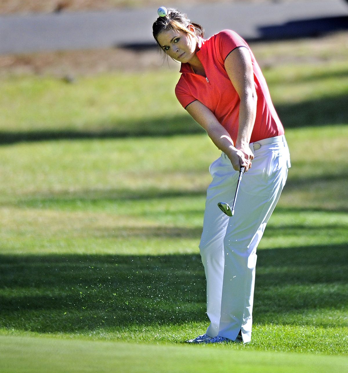 Lauren Howell, who shot a 78, chips onto the 11th green Friday