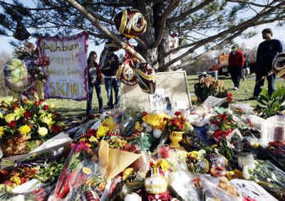 
People visit the makeshift memorial of slain Redskins safety Sean Taylor at the team's training center in Ashburn, Va. Associated Press
 (Associated Press / The Spokesman-Review)