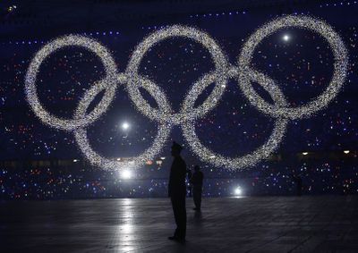 The five-ring Olympic symbol rises from the floor of the stadium during the opening ceremony. (Associated Press / The Spokesman-Review)