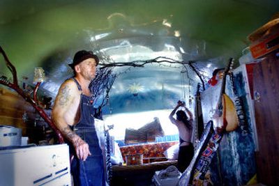
Daniel Manor, left, and Patricia Robison escape the heat of Hempfest inside their modified school bus in Riverfront Park on Friday. 
 (Joe Barrentine / The Spokesman-Review)