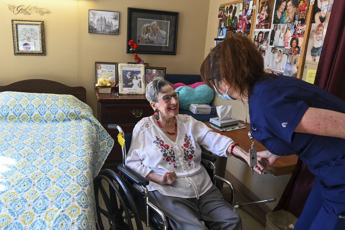 Resident Eleanor Garrison, left, talks with director of nursing Cheri Place-Chafin in her room Wednesday, Feb. 3, 2021, at Arbor Springs Health and Rehabilitation Center in Opelika, Ala. Coronavirus cases have dropped at U.S. nursing homes and other long-term care centers over the past few weeks, offering a glimmer of hope that studies and health officials link to various factors, including the start of vaccinations, the easing of a post-holiday virus surge and better prevention. (Julie Bennett/Associated Press)
