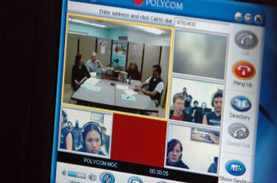 
Students at the Coeur d'Alene Tribe's technology center watch, via the Internet, a group of students at Washington State University. The pilot program began Tuesday.
 (The Spokesman-Review)