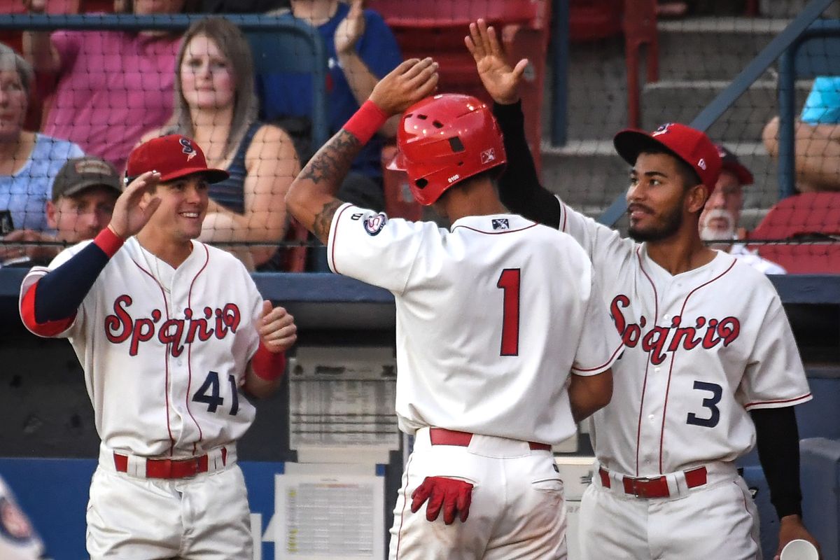 Spokane Indians Obie Ricumstrict (1) is welcomed home teammates Jake Hoover (41) and Jonah McReynolds (3) after scoring their first run against the Eugene Emeralds, Monday, Aug. 19, 2019, at Avista Stadium.  (DAN PELLE)