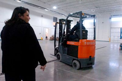 
Elsa Duvall  walks the loading area of the new Centennial Distributing building in Hayden on Wednesday. The  beer distributor  will move into the new building soon. 
 (Jesse Tinsley / The Spokesman-Review)