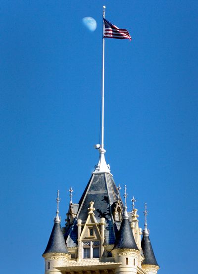 The Spokane County Courthouse frames the moon on a sunny afternoon.  (Spokesman-Review Photo Archives)