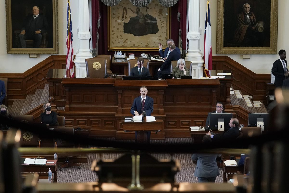Texas State Rep. Andrew Murr, R-Kerrville, center, answers questions of fellow lawmakers as they debate voting bill SB1 in the House Chamber at the Texas Capitol, Thursday, Aug. 26, 2021, in Austin, Texas.  (Eric Gay)
