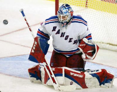 
New York Rangers goalie Henrik Lundqvist deflects a shot on goal against the Boston Bruins in the third period last Saturday. He will represent his home country of Sweden in the Olympics.
 (Associated Press / The Spokesman-Review)