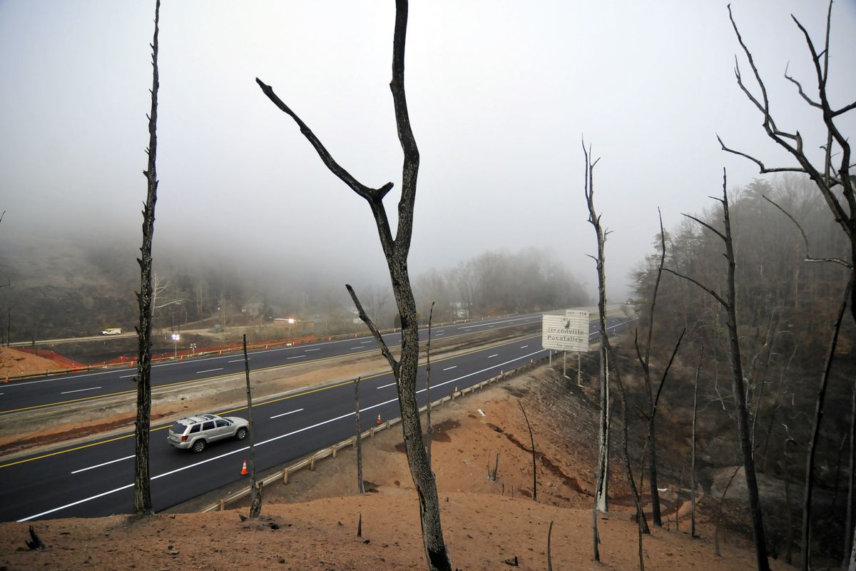 Charred trees are all that stand on the along Interstate 77 Wednesday Dec. 12, 2012, where a gas line ruptured and exploded in Sissonville, W.Va., Tuesday. The interstate pavement melted from the heat of the explosion, shutting down Interstate 77 overnight. But the northbound lanes of the interstate reopened at 8am Wednesday, and the southbound lanes a few hours later. Investigations into what caused the massive blast in a 20-inch Columbia Gas Transmission line are under way. (Tom Hindman / The Charleston Daily Mail)