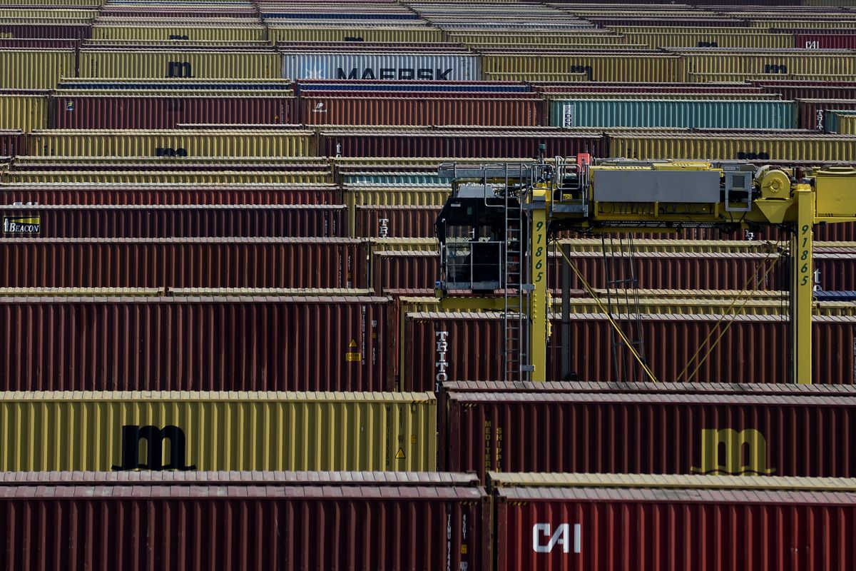 FILE - In this Monday, April 27, 2020 file photo, containers are moved in a container terminal in the Port of Antwerp. Judicial and law enforcement authorities in Belgium have dismantled an organized criminal network responsible for drugs trafficking involving corrupt police officers as they seized more than 2 million euros and some 3.5 tons of cocaine. (Johanna Geron)