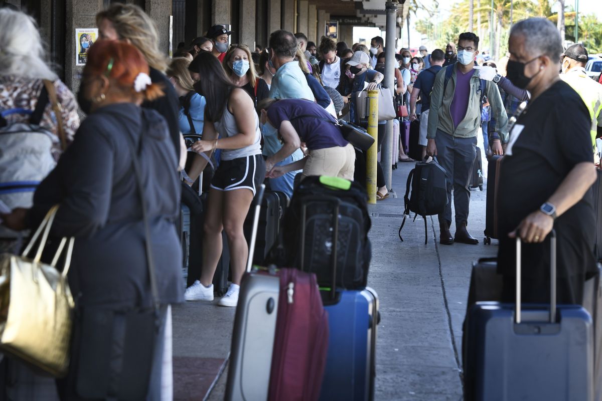 A long line of travelers wait to pass through a state agriculture inspection at the Kahului Airport on the Hawaiian island of Maui Thursday, June 3, 2021. The Hawaiian island of Maui has become so overrun with tourists in recent months that its mayor is taking the unusual step of pleading with airlines to fly in fewer people.  (Matthew Thayer)