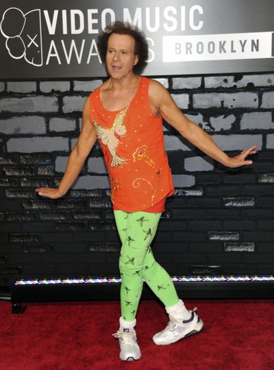 In this Aug. 25, 2013 file photo, Richard Simmons arrives at the MTV Video Music Awards in the Brooklyn borough of New York. Despite what seems to be a national obsession with the fitness gurus wellbeing, his publicist, manager, brother and two officers from the LAPD have all said the 68-year-old is at home in the Hollywood Hills and doing fine. (Evan Agostini / Invision via Associated Press)