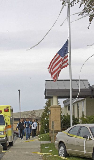 
Students gather outside  Weston High School as the flag flies at half staff on Friday. 
 (Associated Press / The Spokesman-Review)