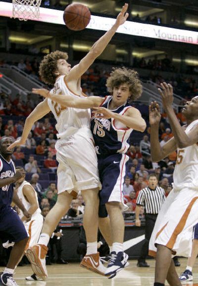 
Gonzaga's Matt Bouldin loses the ball on a drive to the basket in the first half as Texas' Matt Hill, left, defends. 
 (Associated Press / The Spokesman-Review)
