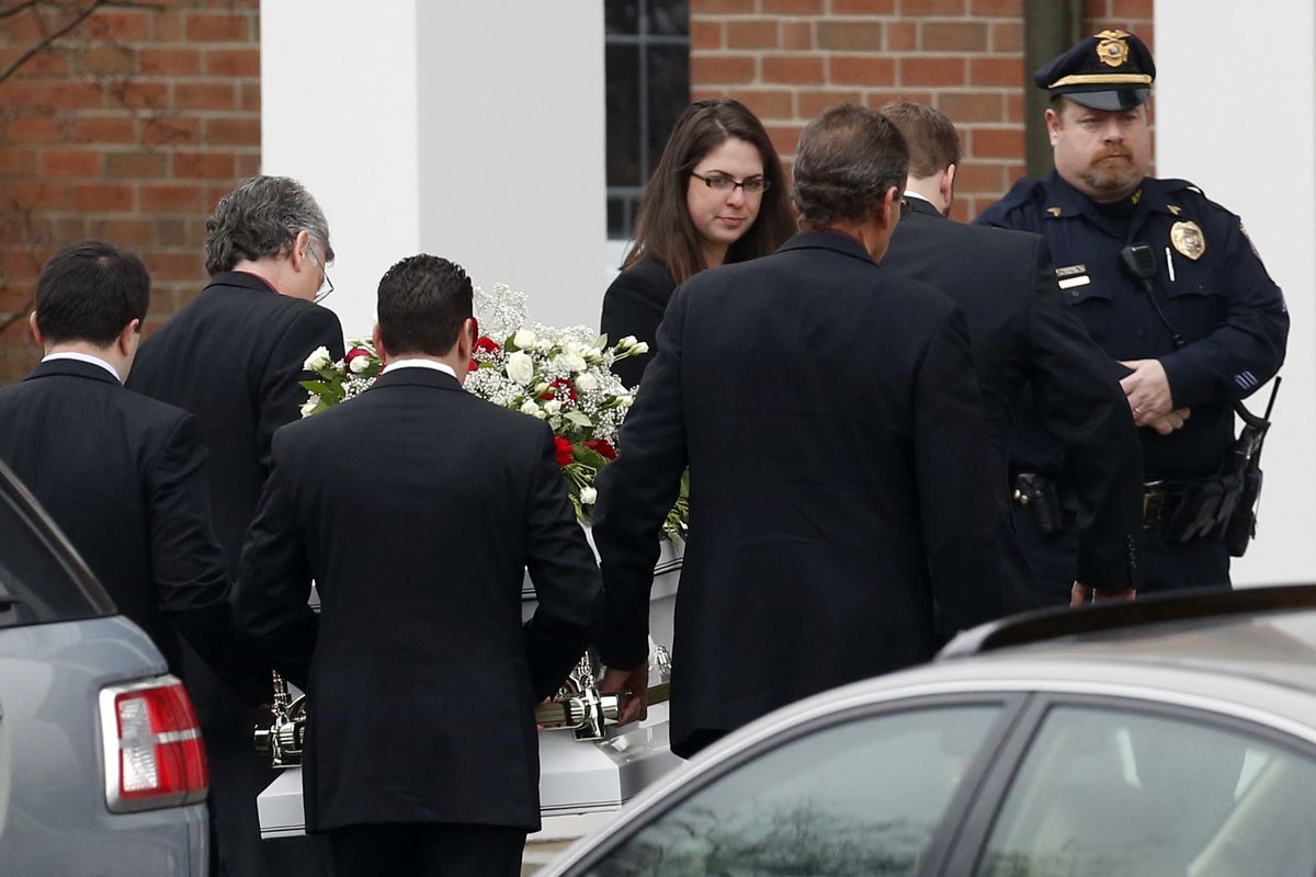 Pallbearers carry the casket containing the body of James Mattioli into St. Rose of Lima Roman Catholic Church for funeral services,  Tuesday, Dec. 18, 2012, in Newtown, Conn. Mattioli, 6, was killed when Adam Lanza walked into Sandy Hook Elementary School in Newtown, Conn., Dec. 14,  and opened fire, killing 26 people, including 20 children, before killing himself. (Julio Cortez / Associated Press)