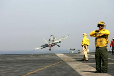
A flight deck director signals as an F/A-18 jet takes off from the USS John C. Stennis on Tuesday while on maneuvers in the Persian Gulf.
 (Associated Press / The Spokesman-Review)