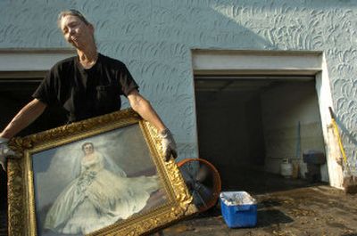 
Trice Flair recovers her mother's bridal portrait from the home she shares with her mom and her disabled older brother Wednesday in New Orleans. 
 (Associated Press / The Spokesman-Review)