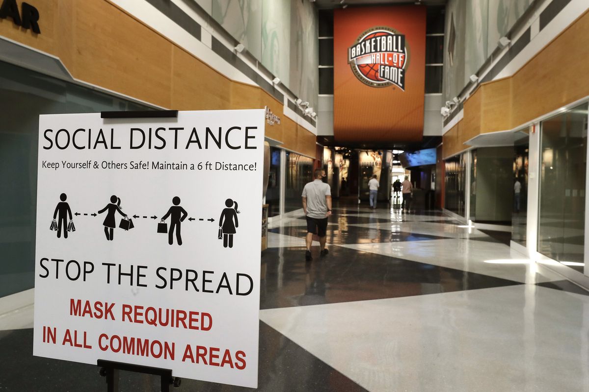 A sign advising safety measures for the coronavirus stands near an entrance to the Naismith Memorial Basketball Hall of Fame, in Springfield, Mass., Tuesday, June 23, 2020. The museum is scheduled to reopen in the beginning of July 2020 with a whole new look after a $22 million renovation.  (Associated Press)