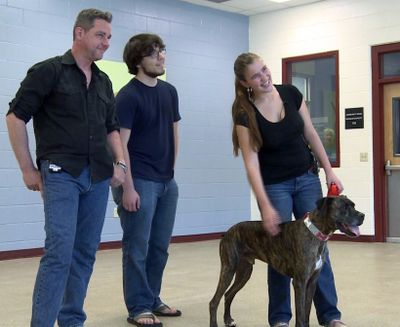 Lloyd Goldston and his children are reunited with their dog, Boozer, in Golden, Colo.