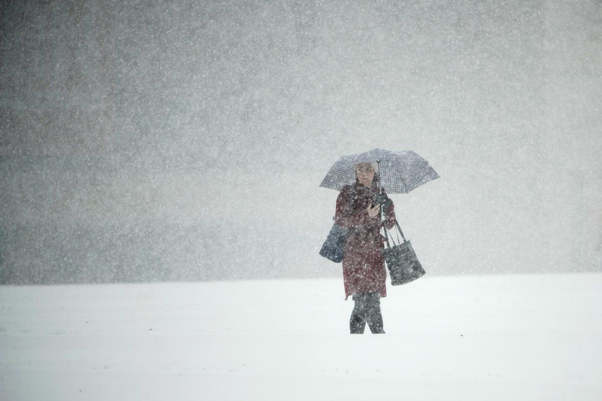 A person walks across Independence Mall during a snow storm in Philadelphia, on Thursday, Nov. 15, 2018. (Matt Rourke / AP)
