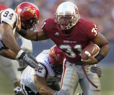 
Washington State running back Dwight Tardy stiff-arms a San Diego State defender and fights for extra yards near the end zone. 
 (Christopher Anderson / The Spokesman-Review)