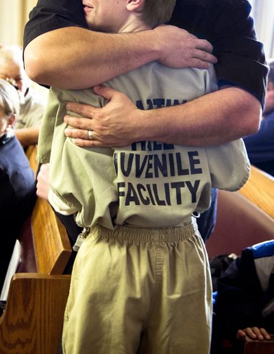 Kimo Morrison embraces the 11-year-old boy sentenced to four years in juvenile detention at the Stevens County Courthouse. The boy was convicted of plotting to kill a female classmate at Fort Colville Elementary in February, 2013. COLIN MULVANY colinm@spokesman.com (Colin Mulvany / The Spokesman-Review)
