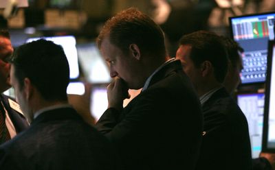 Traders react during early activity on the floor of the New York Stock Exchange on Wednesday. Wall Street showed a modest advance in the final session of a dreadful year. (Associated Press / The Spokesman-Review)