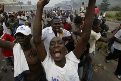 
Supporters of President Laurent Gbagbo run through the streets of Abidjan, Ivory Coast, on Wednesday.
 (Associated Press / The Spokesman-Review)