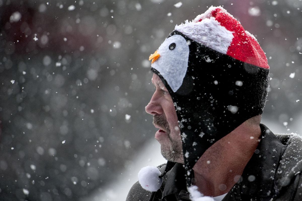 "The snow is here now Santa can come," said Brent Porter, Riverpark Square building engineer, as he wore his penguin/Santa hat in Spokane on Friday, Dec. 15, 2017. (Kathy Plonka / The Spokesman-Review)