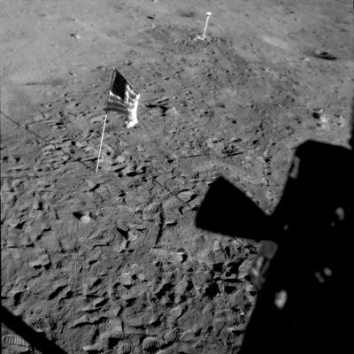 NASA shows a U.S. flag planted at Tranquility Base on the surface of the moon, and a silhouette of a thruster at right, seen from a window in the Lunar Module July 21, 1969.  (HOGP)