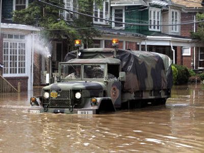 
Water spouts from the exhaust as a military truck drives in floodwaters from the  Delaware River in a neighborhood of Trenton, N.J., as service members check for  residents Thursday. 
 (Associated Press / The Spokesman-Review)