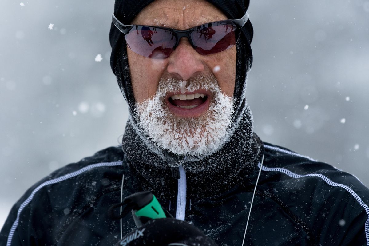 Skier Sam Schlieder crosses the finish line with a frozen beard during the 2018 Langlauf 10K Cross Country Ski Race on Sunday, Feb. 18, 2018, at Mount Spokane State Park. (Tyler Tjomsland / The Spokesman-Review)
