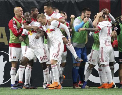 In this May 20, 2018 file photo, New York Red Bulls forward (99) Bradley Wright-Phillips (far left) is mobbed by teammates after scoring in Atlanta. The Red Bulls won the game 3-1. (Curtis Compton / Atlanta Journal-Constitution via AP)